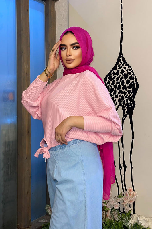 loose blouse with long sleeves and a knot at the waist